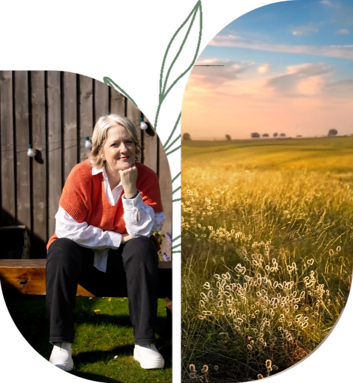 A woman sitting on the ground next to a field.
